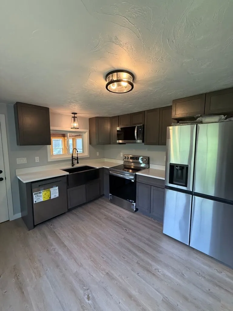 Renovated kitchen with bright cabinets and updated finishes