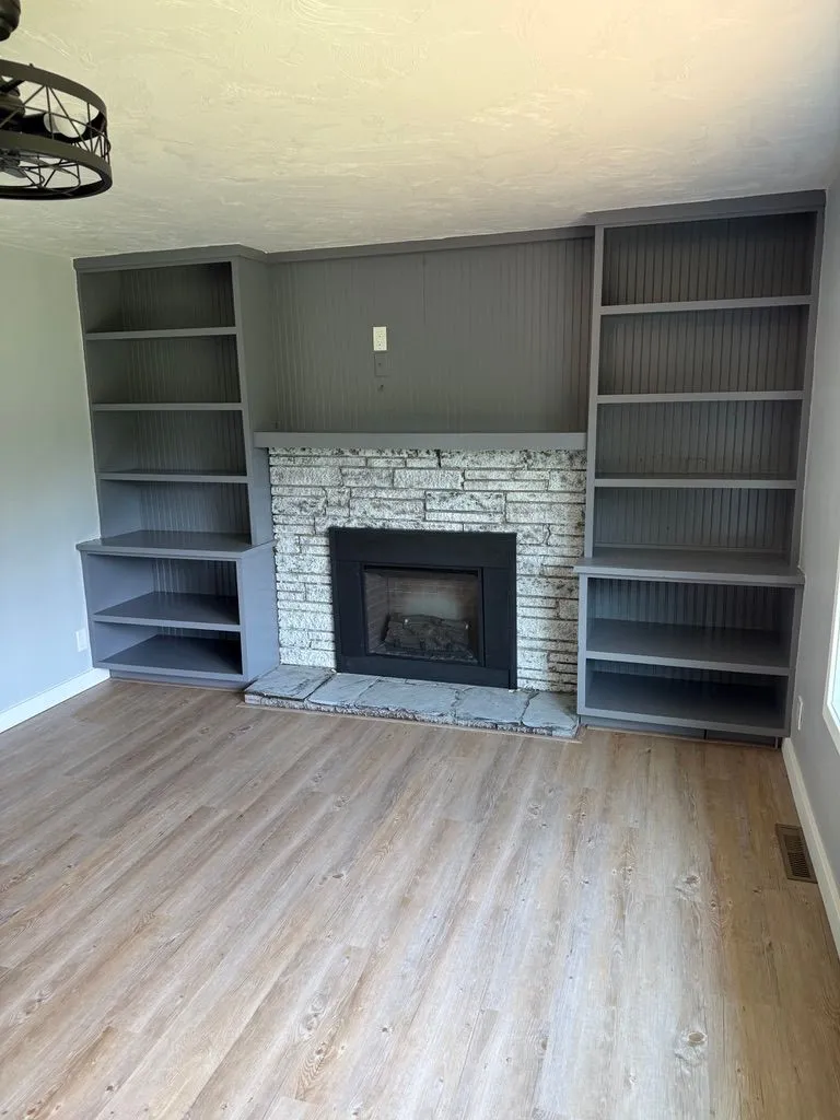 Renovated living room with fresh gray built-ins and a finished fireplace